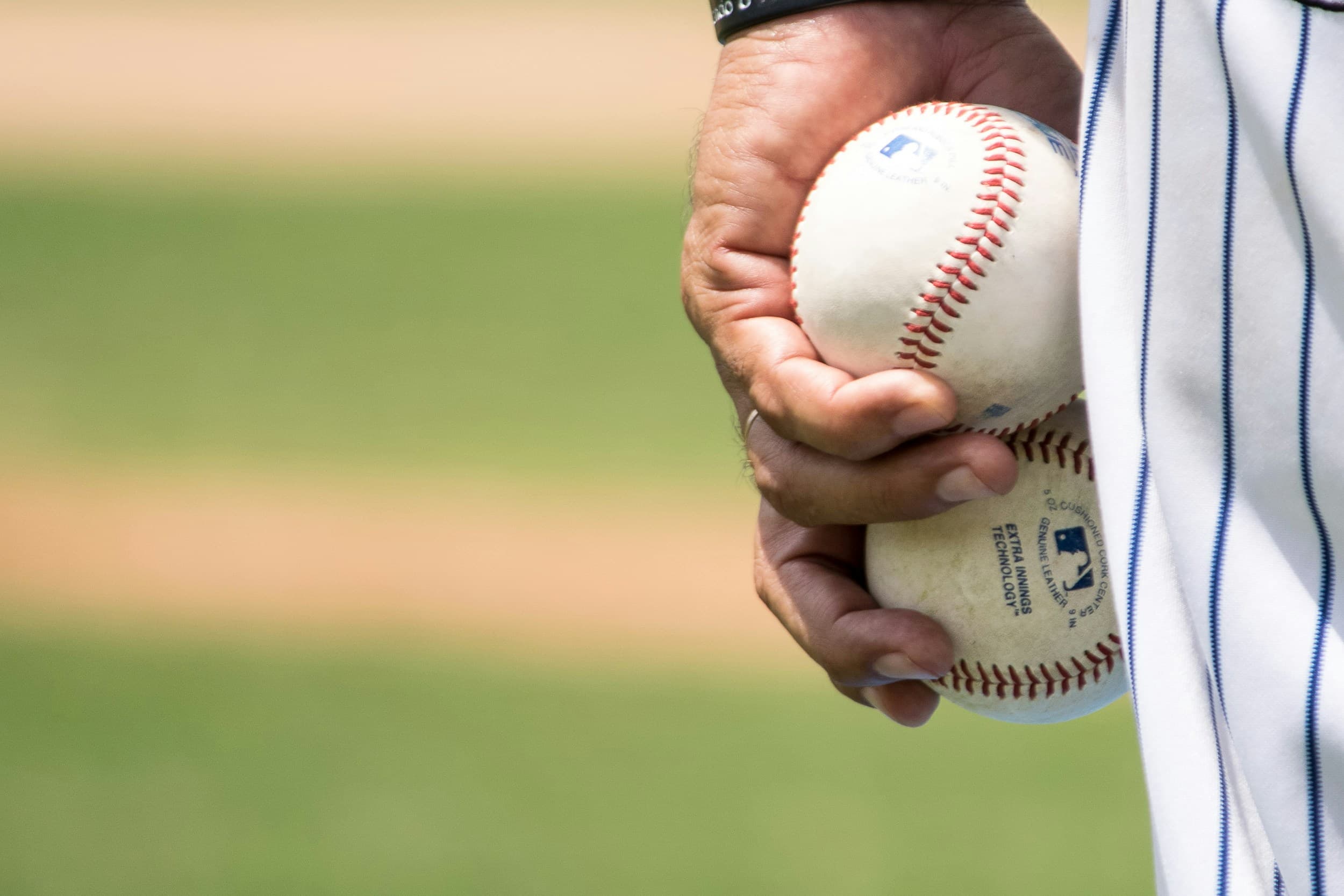 Pitcher gripping two baseballs