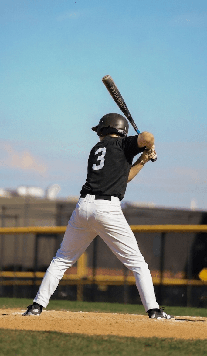 Young hitter loading his swing at the plate